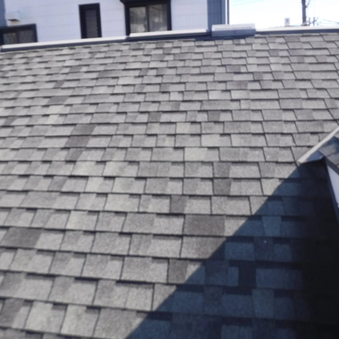 神戸市長田区にてアスファルトシングル屋根の塗装作業を進めてい...